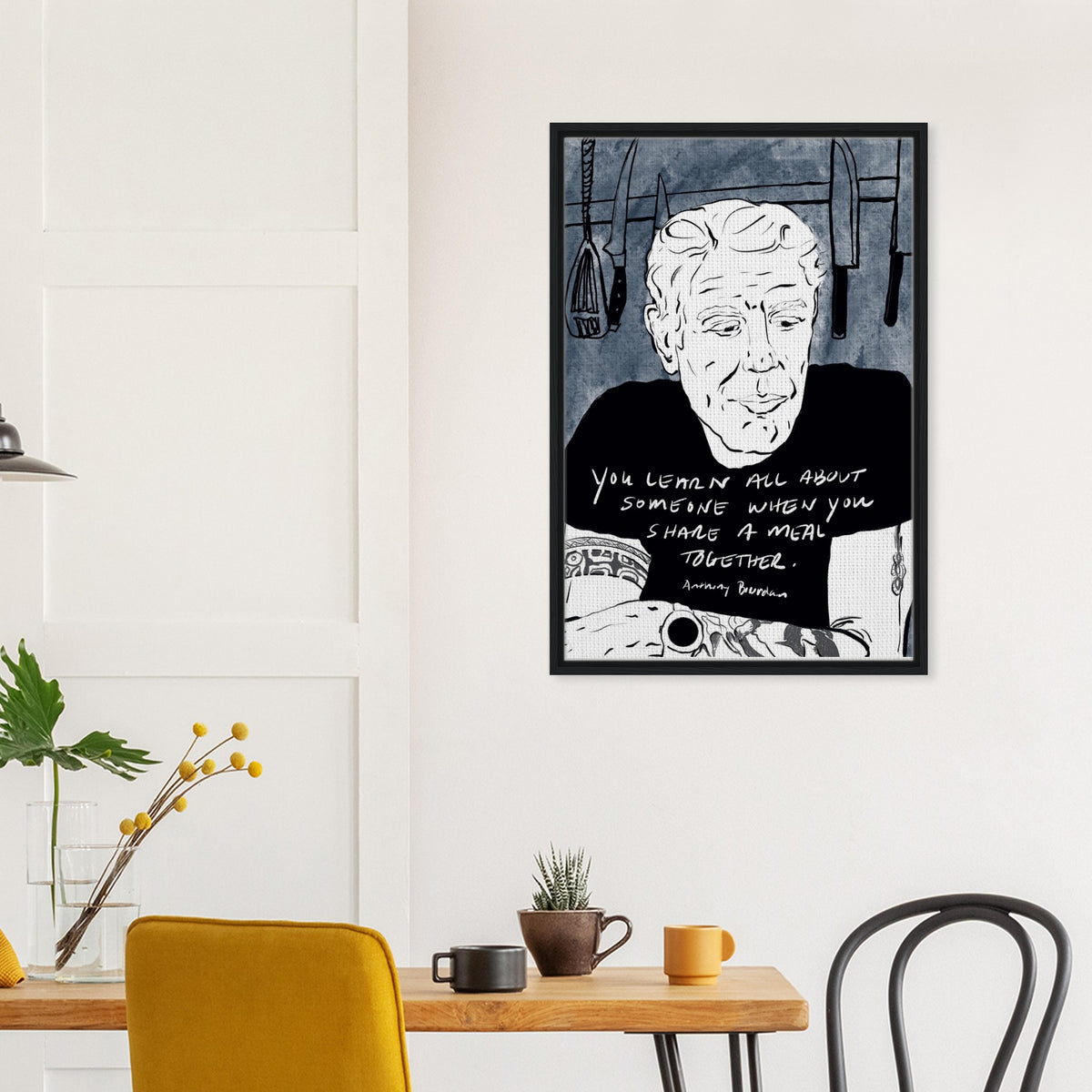 Black and white Anthony Bourdain portrait framed canvas print with blue textured background and quote about sharing meals, perfect kitchen and dining room wall art for food lovers and chefs.